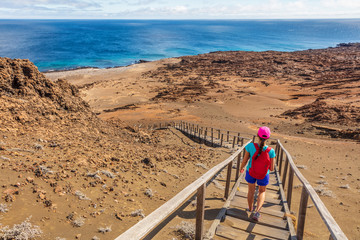 Fototapeta na wymiar Galapagos tourist hiking enjoying famous Bartolome Island. Travel vacation adventure woman on hike to viewpoint and visitor site of landscape.