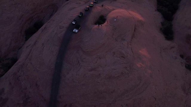 Aerial Drone Offroading 4x4's & 4 Wheelers Driving Hell's Revenge Trail at Sand Flats Recreation Area Near Moab, Utah U.S.A. Wheeling