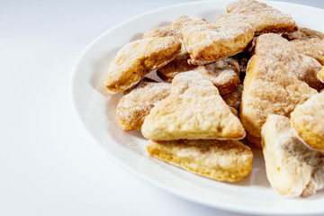 Plate of cookies on a white background close-up. The concept of sweets for tea.