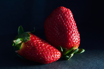 strawberries with natural light and black background