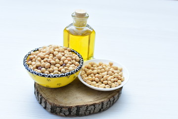 Raw soybeans (Glycine max) displayed in containers and accompanied by oil