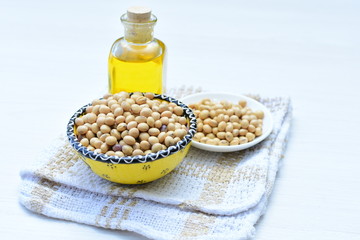 Raw soybeans (Glycine max) displayed in containers and accompanied by oil