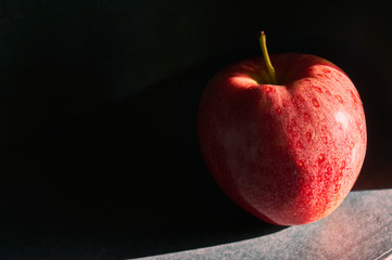 red apples in hand made basket with blue background