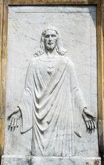 Fototapeta na wymiar Old Ressurrected Jesus Christ High relief in cementery crypt entrance. 