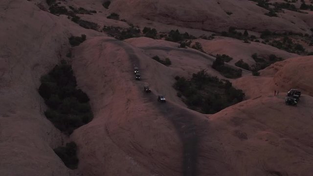 Aerial Drone Offroading 4x4 Four Wheelers Driving Hell's Revenge Trail at Sand Flats Recreation Area Near Moab, Utah U.S.A.