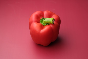 Close up of red capsicum on red background 