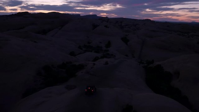 Offroading Four Wheelers 4x4 Jeepers Driving Hell's Revenge Trail at Sand Flats Recreation Area Near Moab, Utah U.S.A. Aerial Drone Footage