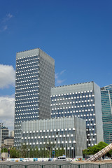 Fototapeta premium Blue sky, white clouds and modern urban architecture