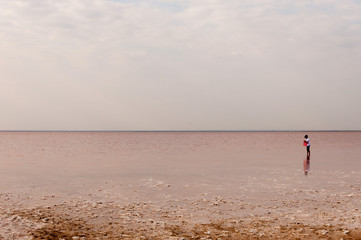 Obraz premium A boy collects salt on the Sasyk-Sivash lake.