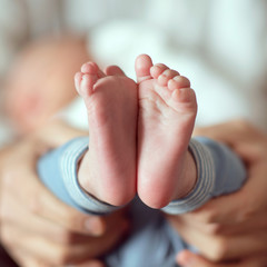 Feet of a baby in father's hands - 328411989