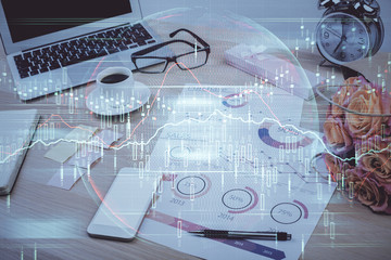 Double exposure of chart and financial info and work space with computer background. Concept of international online trading.