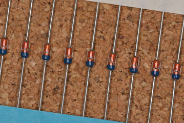 Electronic components, Glass molded small signal diode (Cork board textured background)