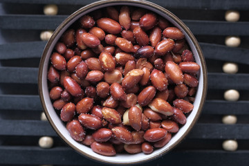 top view of fresh pea nut in a bowl on table 
