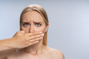 Frightened female experiencing a panic attack indoors