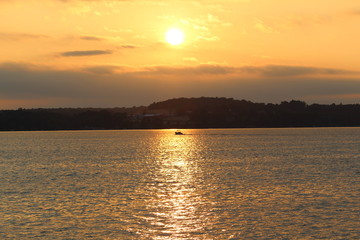 sunset on the lake with boat