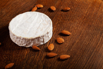 Camembert cheese or brie on wooden background.