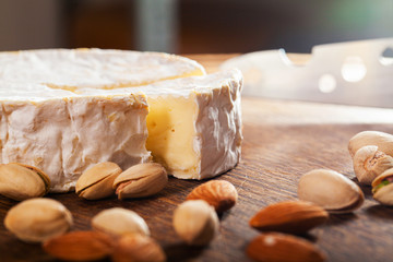 Camembert cheese or brie on wooden background.