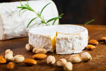 Camembert cheese or brie on wooden background.
