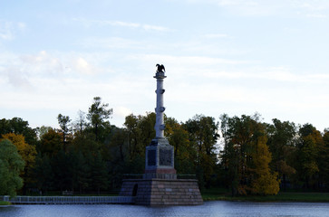 Autumn park with a lake and architecture.