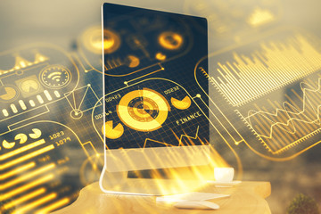 Computer on desktop in office with technology theme hologram. Multi exposure. Tech concept.