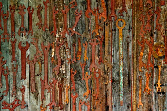 Antique wrench abstract.  Rusted tools displayed on barn wall