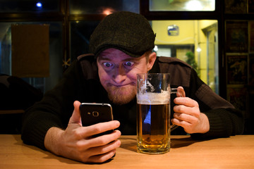 Guy and phone in the bar
