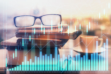 Financial graph hologram with glasses on the table background. Concept of business. Double exposure.