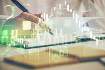 Multi exposure of woman's hands making notes with forex graph hologram. Concept stock market analysis.