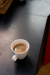 black coffee in white cup on coffee maker