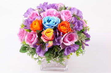 Colorful flower arrangement centerpiece in square glass vase