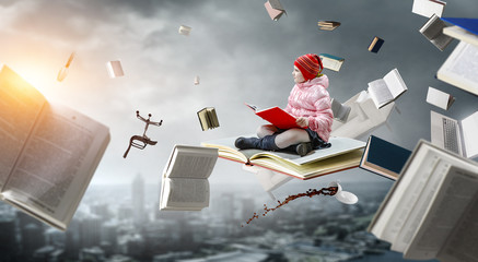 Little girl reading a book