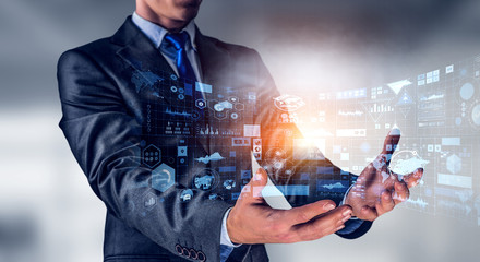 A businessman working on a touch screen.