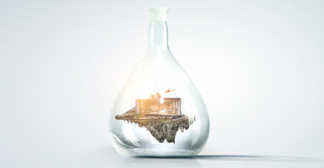 House and grass inside a glass bottle