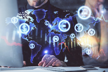 Forex graph with businessman typing on computer in office on background. Concept of analysis....