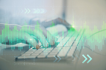 Forex graph with businessman working on computer in office on background. Concept of hardworking. Closeup. Multi exposure.