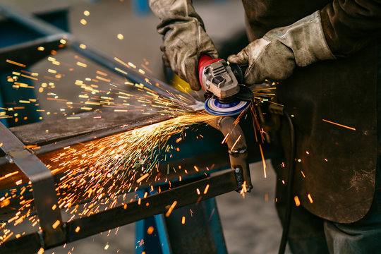 Factory Worker Grinding A Metal,close Up