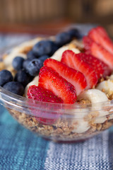 A closeup view of a fruit acai bowl in a restaurant or kitchen setting.