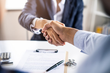 Successful handshake of man customer and house agency. Couple making sign contract then shaking...
