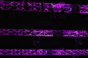 Stage metal truss during show with purple light reflection