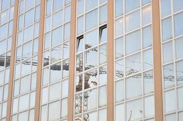 Crane reflection on building's windows