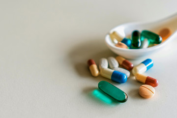 Mixed of pill or tablet medicine on white spoon on white background. Health care medicine cure...