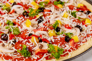 Raw pizza with mushroom, pepperoni and pineapple.