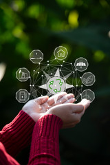 Technology, hand holding with environment Icons over the Network connection on green background.