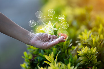 Technology, hand holding with environment Icons over the Network connection on green background.