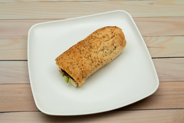 Bread sandwich with square and white plate