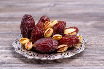 Fototapeta na wymiar Dried dates with pistachios