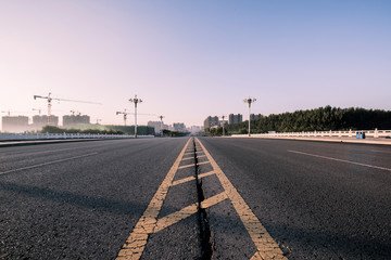 The background of asphalt roads and bridges at sunrise