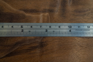 macro photo of a ruler on walnut wood background