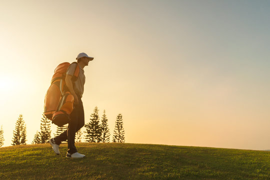 Blurred images of golfers who walking and carrying golf bags in the golf club.