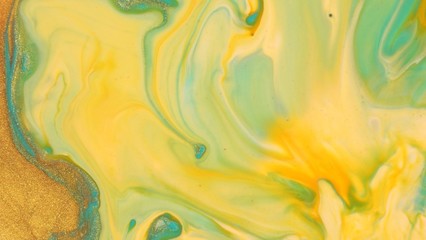 Light blue and gold liquid glitter paint mix. Abstract background. A real beautiful substance flows. Motion mixed colorful ink macro 